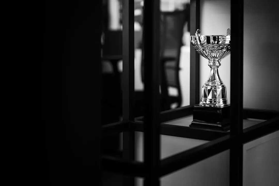 Silver trophy on a table, representing real physical prizes for gaming tournament winners